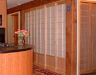 Shoji screens conceal the pantry closet and messy cork board wall