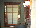 Shoji panel suspended in a wall opening
