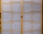 Bipart shoji doors using a barn door style tracking system
